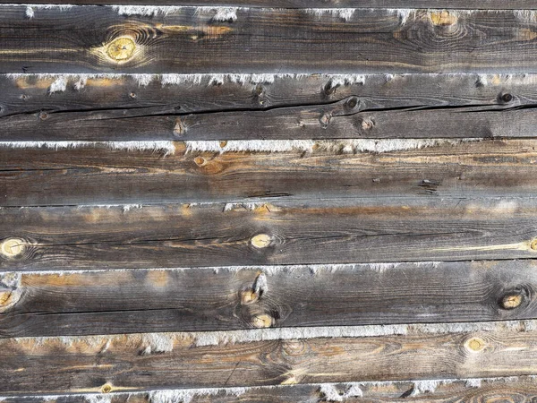 这堵墙是用木料筑成的 两根杠中间拖着两根 木头上的裂缝 — 图库照片