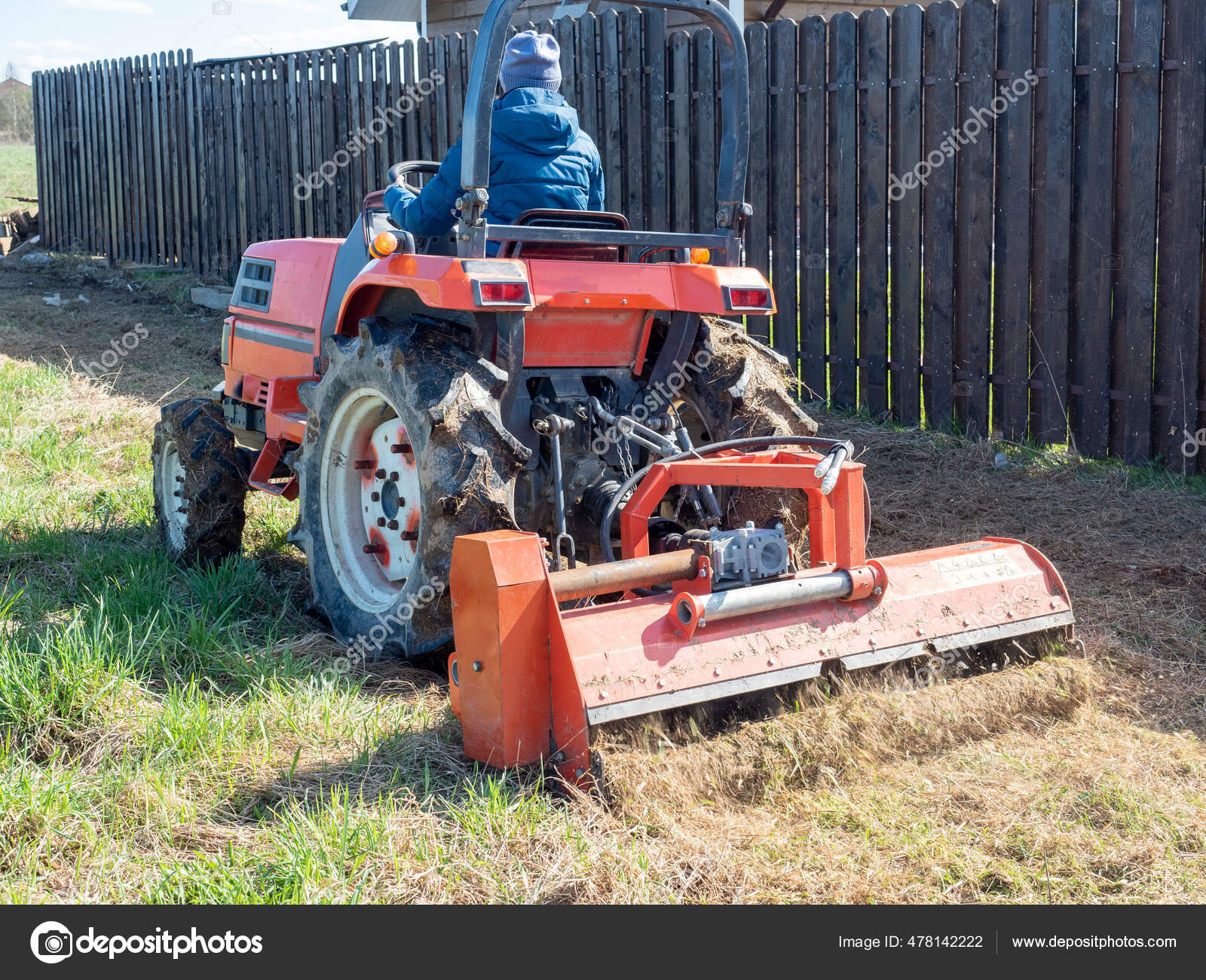 Man Sits Small Tractor Drives Field Mulching Grass Land