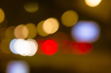 blurred background of night city and roads orange red and blue side lights and roads. High quality photo