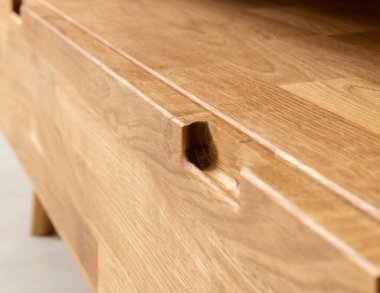 Drawers close view photo, wooden furniture elements background. Furniture details