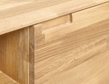 Wooden drawer with a handle close view photo, wooden furniture elements background. Furniture details