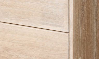 Bedside table with drawers close view photo, wooden eco furniture elements background. Solid wood furniture details