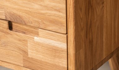 Bedside table with drawers close view photo, wooden eco furniture elements background. Solid wood furniture details