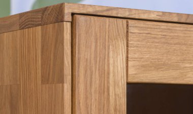 Cupboard door close view photo, wooden eco furniture elements background. Solid wood furniture details