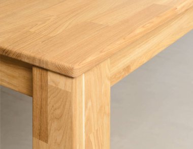 Wooden table corner with a leg close view photo, wooden furniture background