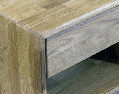 Wooden drawer of a nightstand close view photo, wooden eco furniture elements background. Solid wood furniture details