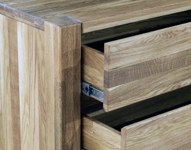 Opened wooden drawers with sliders close view photo, wooden eco furniture elements background. Solid wood furniture details