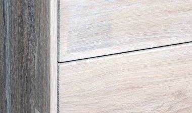 Bedside table with drawers close view photo, wooden eco furniture elements background. Solid wood furniture details