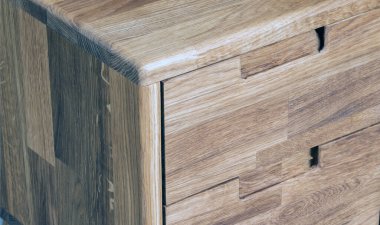 Bedside table with drawers close view photo, wooden eco furniture elements background. Solid wood furniture details