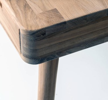 Wooden table corner and leg close view photo, wooden eco furniture elements background. Solid wood furniture leg