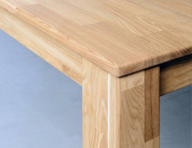 Wooden table corner with a leg close view photo, wooden furniture background