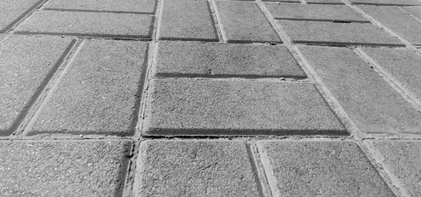 Tuğlaları, yol arka planı, yol yüzeyi yakın görüntüsü, siyah beyaz monokrom fotoğrafı