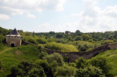Ağaçlara ve çalılıklara gömülmüş eski ortaçağ kalesinin büyük duvarı