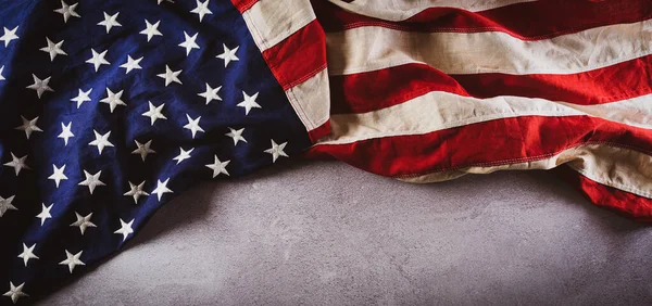 Happy Veterans Day concept. American flags against gray stone  background. November 11.