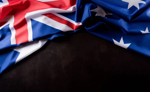 Australia day concept. Australian flag against dark stone background. 26 January.