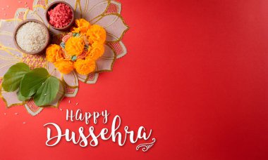 Mutlu Dussehra. Sarı çiçekler, yeşil yaprak ve kırmızı arka planda pirinç. Dussehra Hint Festivali konsepti.