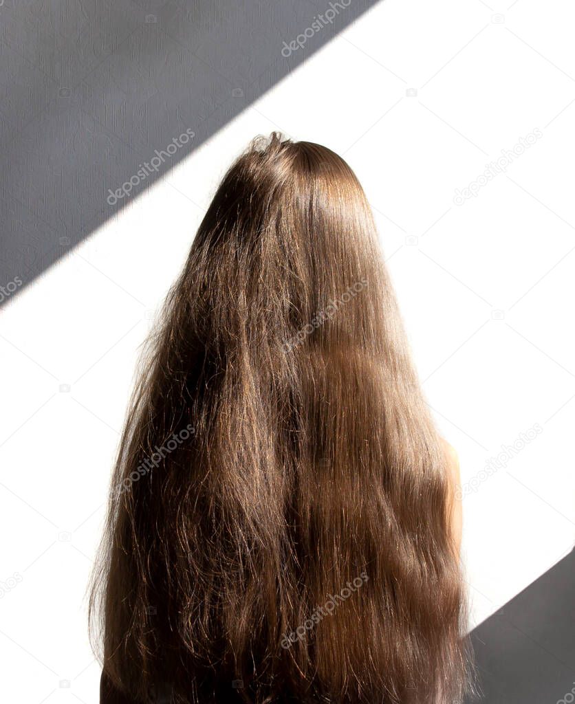 on a white background female head with long hair. before and after using a special shampoo. obedient hair concep