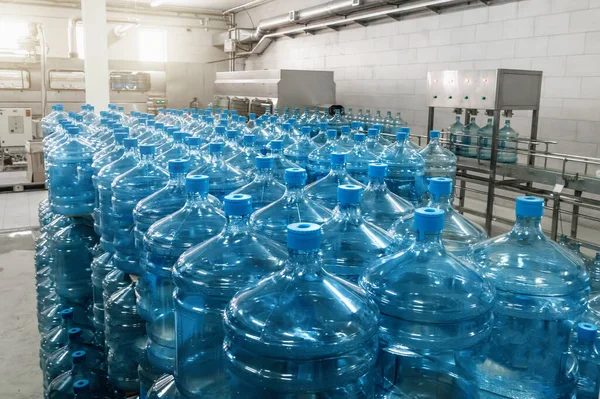 Gallons ou bouteilles en plastique d'eau potable purifiée dans une usine de production d'eau — Photo