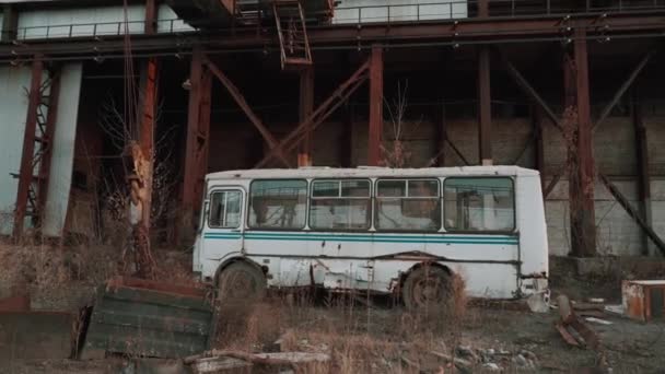 Opuszczony autobus w zardzewiałym krajobrazie przemysłowym z upiorną apokaliptyczną atmosferą — Wideo stockowe