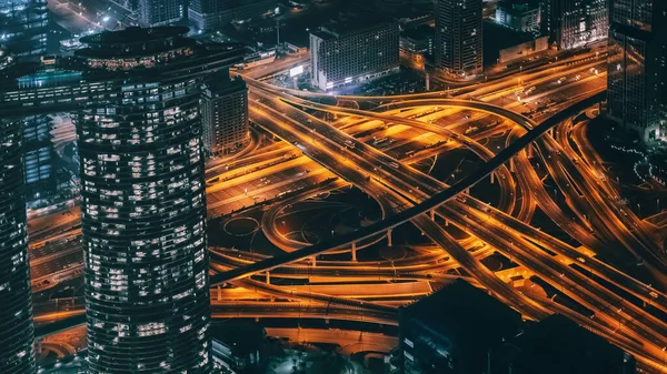 Busy Illuminated Road Intersection at Night among Modern Futuristic Buildings, Top View — Stock Photo, Image