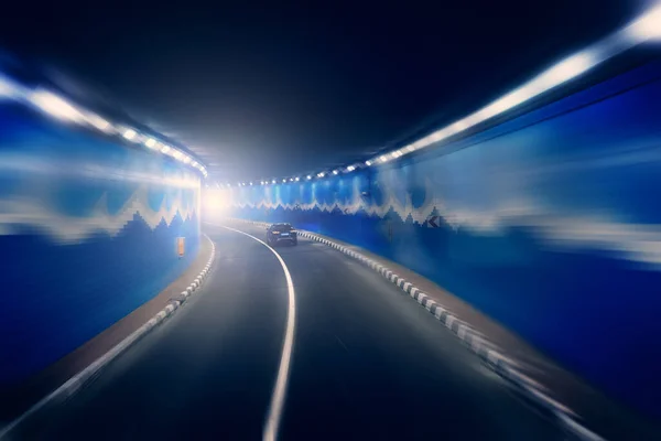Road tunnel with riding car in blurred motion effect