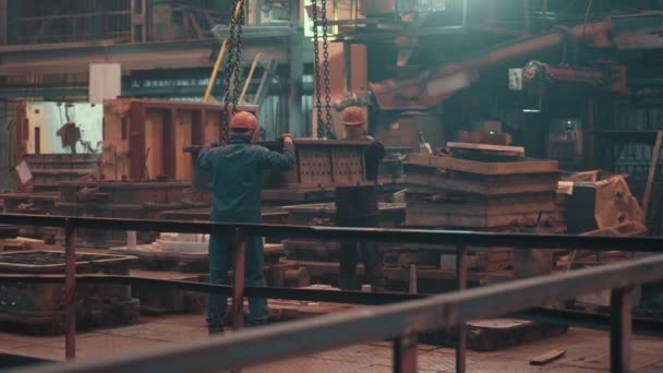 Workers control moving mold for metal casting in foundry, heavy metallurgical industry, steel foundry manufacturing production workshop — 비디오