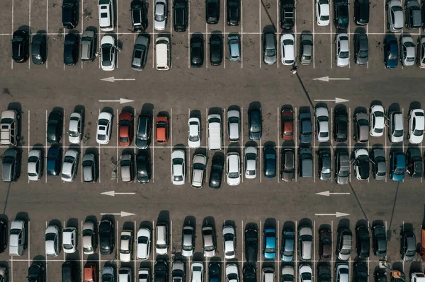 Big parking near shopping center or mall, top aerial view from high