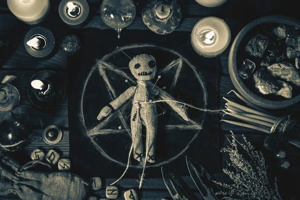 Konsep Sihir Voodoo. Boneka Voodoo diisi dengan jarum dengan hati kain ditindik di pentagram dan sekitar lilin terbakar. Menakutkan atau menakutkan ritual esoteris magis, hitam dan putih foto Stok Gambar