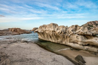 Görkemli, yıpranmış granit oluşumlarının arasına yerleştirilmiş küçük kumlu bir koyun yakın çekim görüntüsü tipik Cala Francese bölgesi. Görüntü, Maddalena Takımadası 'nın vahşi güzelliğini ve huzurlu atmosferini kristal berrak suyla yakalıyor.