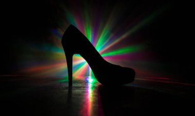 Sanat dekorasyonu. Karanlıkta topuklu kadın ayakkabılarının silueti. Kadın gücü ya da kadın egemenliği kavramı. Seçici odak