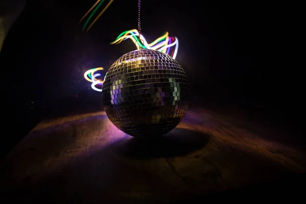 Colorful disco mirror ball lights night club background. Party lights disco ball. Selective focus