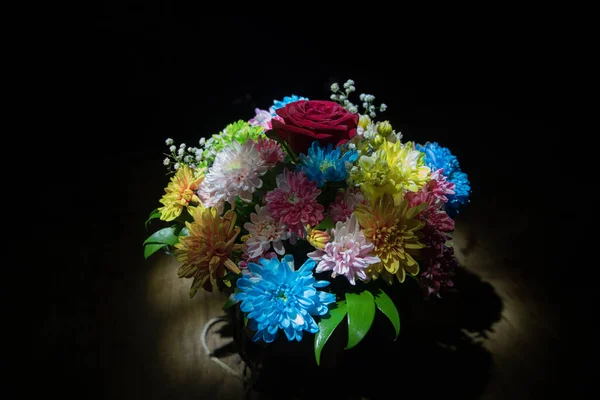 Beautiful and colorful flower bouquet, on dark bakground. Floral bouquet of different flowers. Best for a greeting card. Selective focus