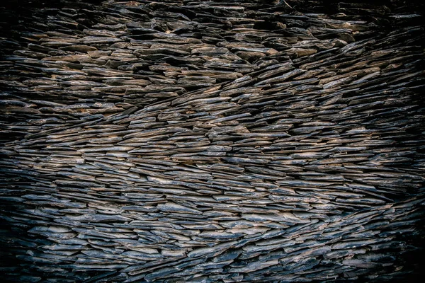 Wall of natural river stone. Ground stone, grey background with many small stones. Rock texture background, macro photography