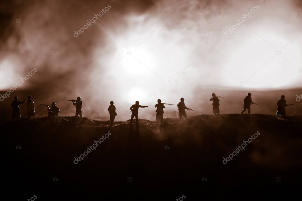 War Concept. Military silhouettes fighting scene on war fog sky background, World War Soldiers Silhouette Below Cloudy Skyline At night. Selective focus