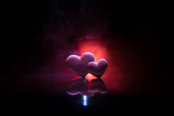 Valentines background. Valentine\'s Day heart on a dark wooden table. Dark toned foggy background. Selective focus