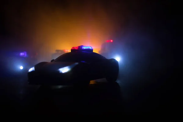 Police car chasing a car at night with fog background. 911 Emergency response police car speeding to scene of crime. Creative decoration. Selective focus