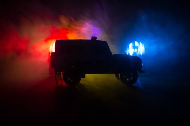 Polis arabası sisli bir arabayı gece takip ediyor. 911 acil durum arabası suç mahalline doğru hızla gidiyor. Yaratıcı dekorasyon. Seçici odak