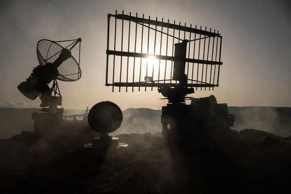 Space radar antenna on sunset. Silhouettes of satellite dishes or radio antennas against night sky. Creative artwork decoration. Selective focus