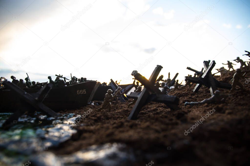 World War 2 reenactment (D-day). Creative decoration with toy soldiers, landing crafts and hedgehogs. Battle scene of Normandy landing on June 6, 1944. Selective focus