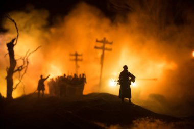 War Concept. Military silhouettes fighting scene on war fog sky background, World War Soldiers Silhouette Below Cloudy Skyline At night. German soldiers in ranks. Selective focus clipart