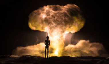 Nükleer savaş konsepti. Nükleer bomba patlaması. Karanlıkta yaratıcı sanat dekorasyonu. Bir insanın siluetine karşı dev mantar bulutu atomik patlama. Seçici odak