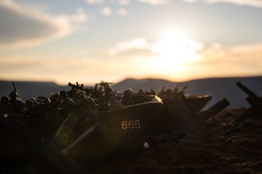 World War 2 reenactment (D-day). Creative decoration with toy soldiers, landing crafts and hedgehogs. Battle scene of Normandy landing on June 6, 1944. Selective focus clipart