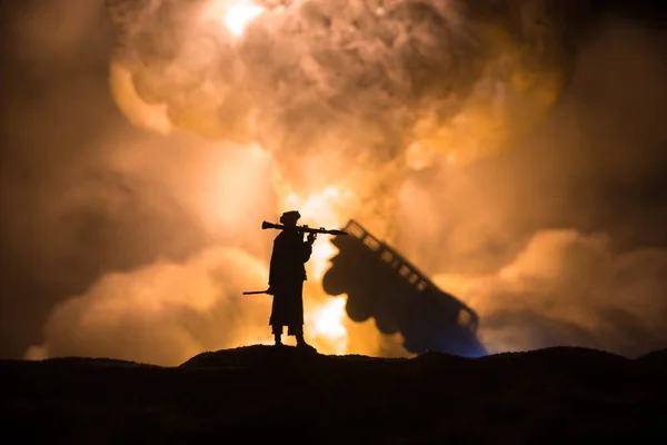 Military soldier silhouette with bazooka. War Concept. Military silhouettes fighting scene on war fog sky background, Soldier Silhouette aiming to the target at night. Attack scene