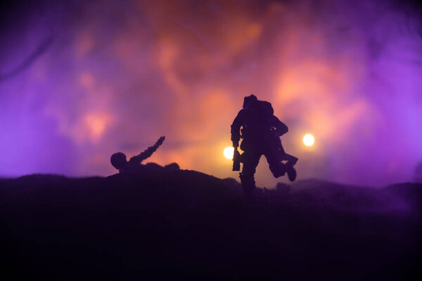 War Concept. Military silhouettes fighting scene on war fog sky background, World War Soldiers Silhouette Below Cloudy Skyline At night. Armored vehicle fight scene. Selective focus