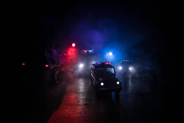 Police cars at night. Police car chasing a car at night with fog background. 911 Emergency response police car speeding to scene of crime. Selective focus