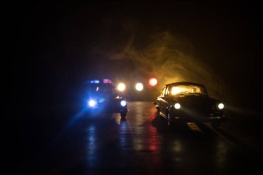 Polis arabası sisli bir arabayı gece takip ediyor. 911 acil durum arabası suç mahalline doğru hızla gidiyor. Seçici odak