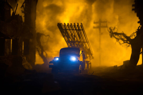 Rocket launch with fire clouds. Battle scene with rocket Missiles with Warhead Aimed at Gloomy Sky at night. Soviet rocket launcher on War Background. Creative composition.