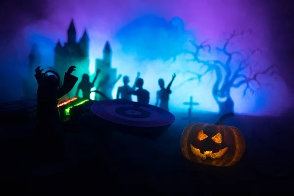 Happy Halloween horror party concept. Scary view of dancing zombies at cemetery with Dj and club lights. Creative artwork decoration. Useful as a party poster or greeting card. Selective focus