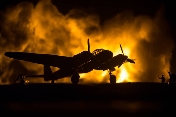 German Junker (Ju-88) night bomber at night. Artwork decoration with scale model of jet-propelled plane in possession. Toned foggy background with light. War scene. Selective focus