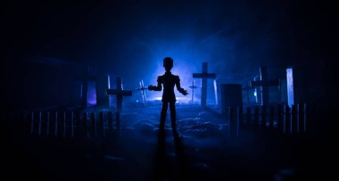 Zombilerin mezarlıktaki ölü ağaç, ay, kilise ve sisli ürkütücü bulutlu gökyüzü, Korku Cadılar Bayramı konsepti. Seçici odak